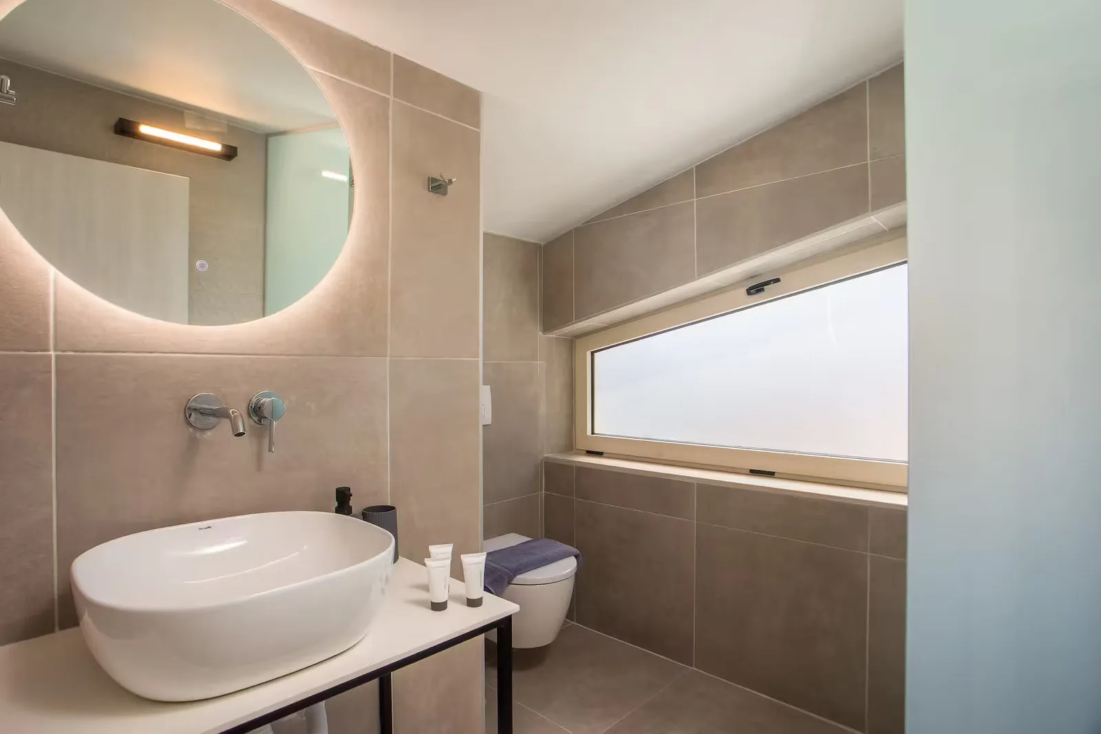 Bathroom with backlit mirror