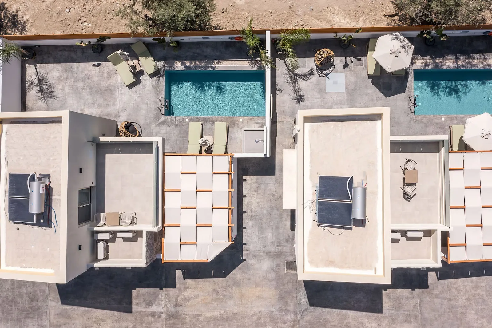 Top-down drone shot of two private pools